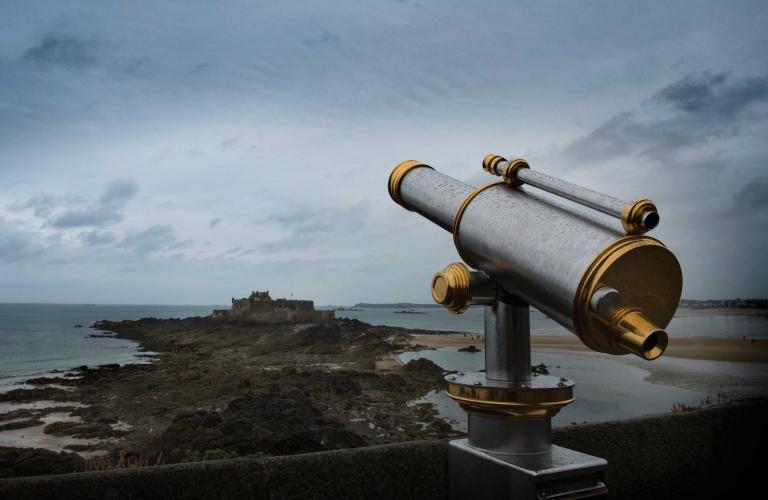 Telescope and a building in the distance.