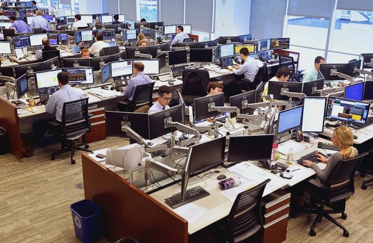 This picture shows people working at their desks