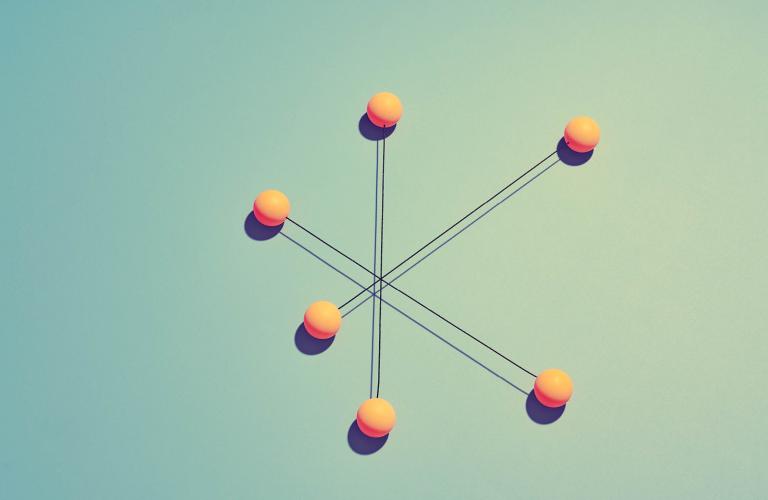 Group of rods with yellow spheres attached to each side, symbolizes connectedness and teamwork efforts