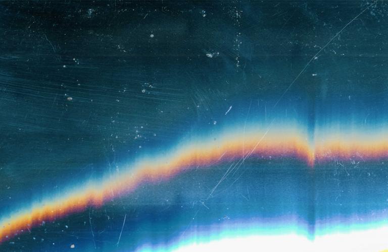 Dark rainbow textured background