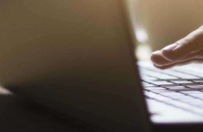 Typing on laptop